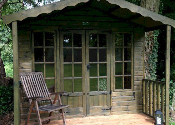 A quality timber summer house with veranda