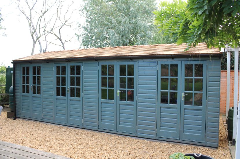 Joinery doors, cedar roof shingles, blue opaque woodstain finish
